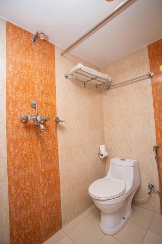 a bathroom with a toilet and a shower at Hotel Crystal Palace in Pokhara