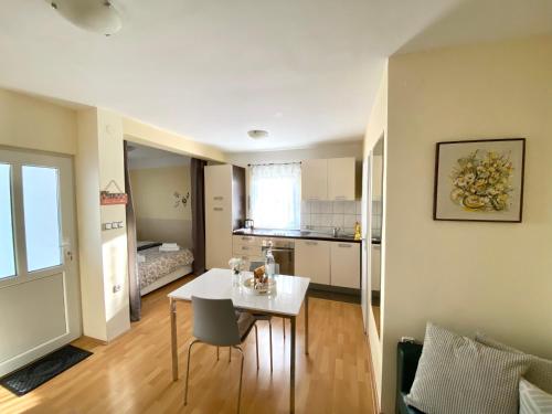 a living room with a table and a kitchen at Apartman Lucija in Gradići