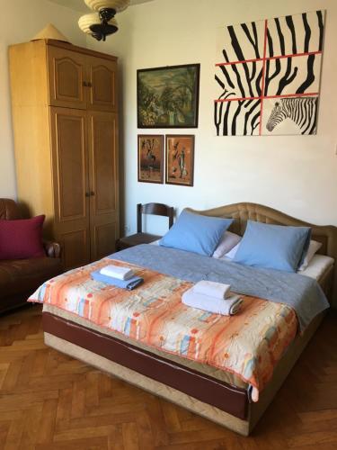 a bedroom with a bed with two towels on it at Art House 001 in Kotor