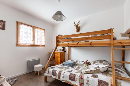 a bedroom with a bunk bed with a ladder at Macazoline in Xonrupt-Longemer