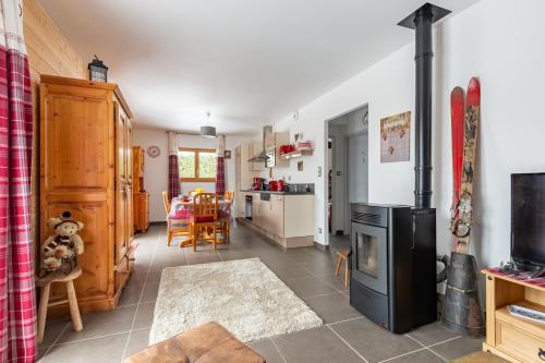 a kitchen and living room with a stove at Macazoline in Xonrupt-Longemer
