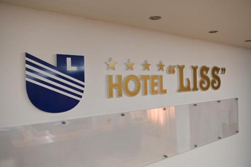 a hotel kiss sign on a wall in a room at Hotel Liss in Lezhë