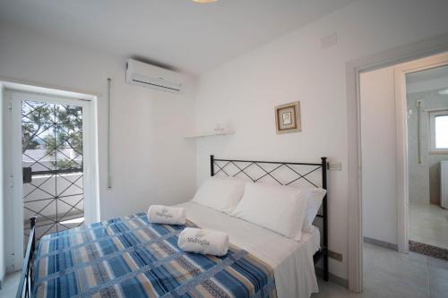 a bedroom with a bed with two towels on it at WePuglia - Dimora Capitolo in Monopoli