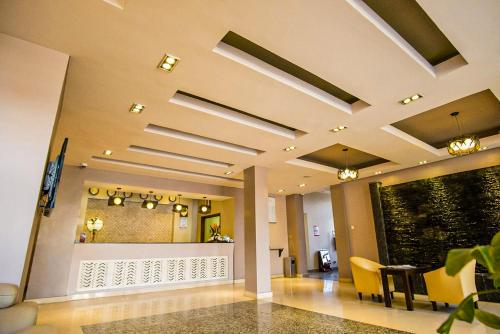 a lobby with a hallway with a table and chairs at Ngong Hills Hotel in Nairobi