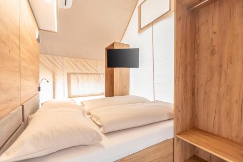 a bedroom with two pillows on a bed at Chalets & Glamping Nassfeld by ALPS RESORTS in Kötschach