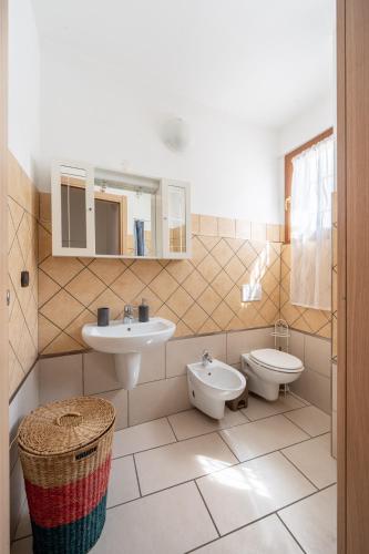 a bathroom with a sink and a toilet and a mirror at [Two Steps From Lake] - Lake Maggiore Relax in Dormelletto
