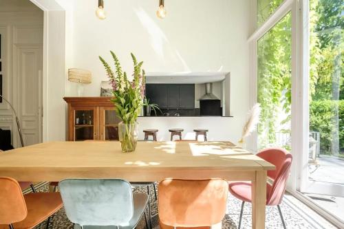 a dining room with a wooden table and chairs at La Calamande En Ville in Brussels