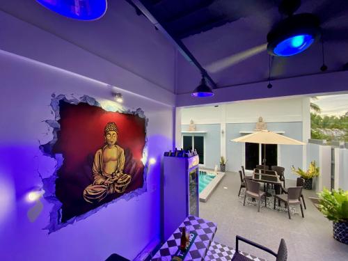 a room with a painting of a buddha on the wall at Sparrow's Nest in Panglao