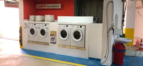 a row of washing machines in a laundry room at HOTEL Apartments ARDO in Golem