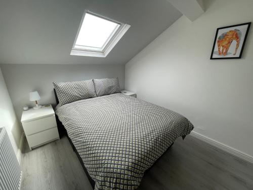 a small bedroom with a bed and a window at Hosted By Ryan - Anfield Apartments in Liverpool