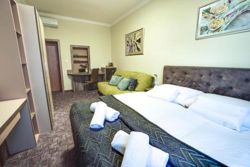 a hotel room with a bed and a couch at Penzión Hradbová Old Town Residence & SPA in Košice