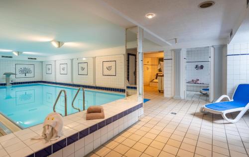 a large swimming pool in a house at Best Western Waldhotel Eskeshof in Wuppertal