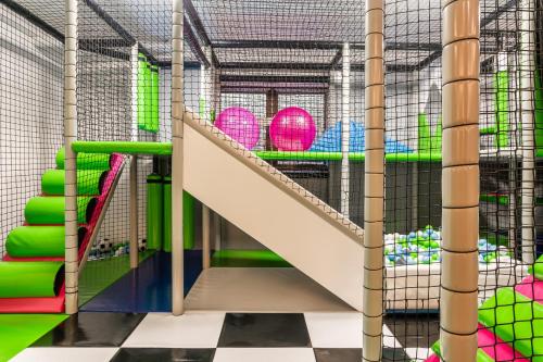 a childrens play room with stairs and balls at Aparthotel Białczański in Białka Tatrzanska