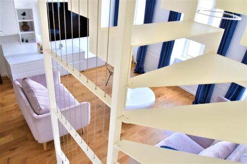 a view from above of a living room with stairs at La Maison du Quai Triplex de charme 4 étoiles en hyper centre avec SPA in Landerneau