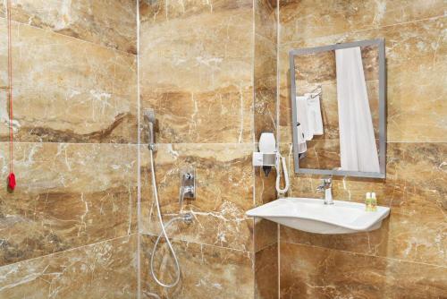 a bathroom with a sink and a shower at Ramada By Wyndham Elbistan in Elbistan