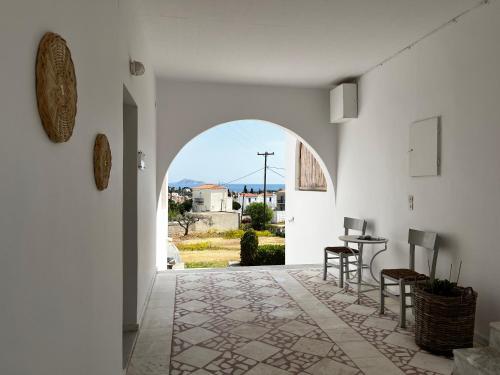 an open hallway with an archway with a table and chairs at SORINA Beloved Rooms in Spetses