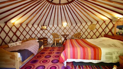 a room with two beds in a yurt at Mas Escombelle in Barjac