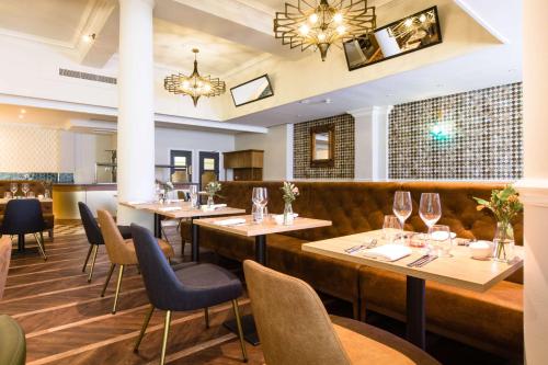 a restaurant with tables and chairs and a bar at The Queen at Chester Hotel, BW Premier Collection in Chester