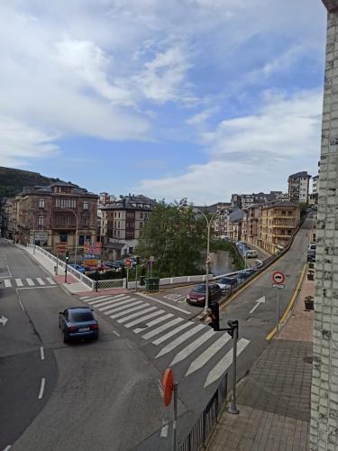 a view of a street with cars driving on the road at apartamento buenavista in Luarca