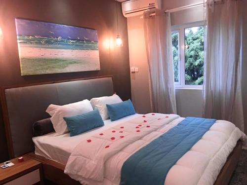 a bedroom with a large bed with roses on it at 2 bedrooms appartement at Flic en Flac 100 m away from the beach with shared pool furnished terrace and wifi in Flic-en-Flac