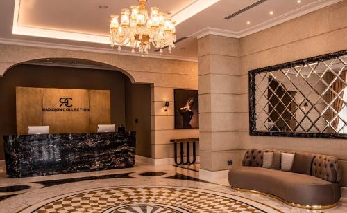 a hotel lobby with a chandelier and a couch at Radisson Collection Morina Hotel, Tirana in Tirana