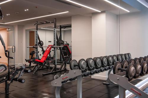 a gym with several tread machines in a room at Radisson Collection Morina Hotel, Tirana in Tirana
