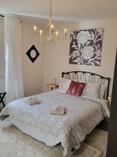 a bedroom with a large bed with two towels on it at Ancient Stone 'Casa Rosa'- Sea and Mountain View Tranquil Borgo in Tavenna