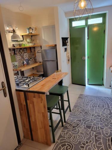 a kitchen with a counter and a green door at Ancient Stone 'Casa Rosa'- Sea and Mountain View Tranquil Borgo in Tavenna