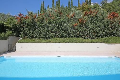 a swimming pool in front of a garden at Villa Bornico Margherita in Toscolano Maderno