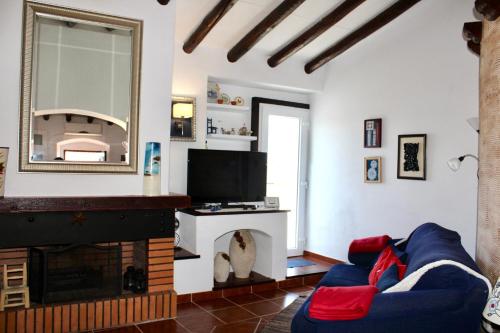 a living room with a blue couch and a fireplace at A nossa Estrela in Moura