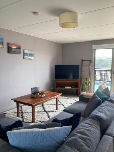 a living room with a couch and a table at House on the hill in Port Campbell