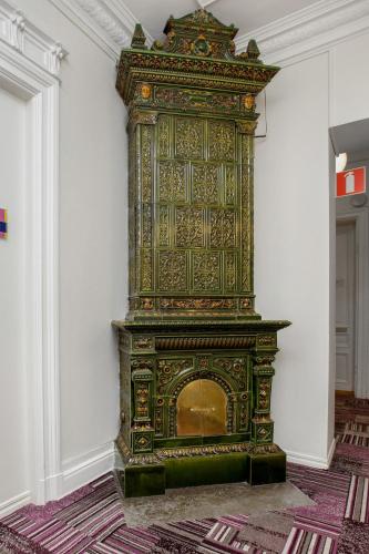 an ornate fireplace in a room with a wall at Ibis Styles Stockholm Odenplan in Stockholm