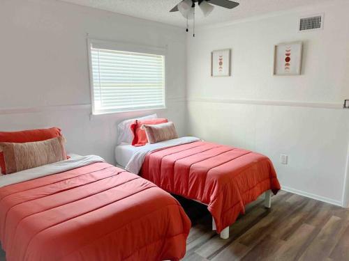 a white room with two beds and a window at Sparkling Guest Home 2 bedroom-15 Minutes to Clearwater Beach in Clearwater