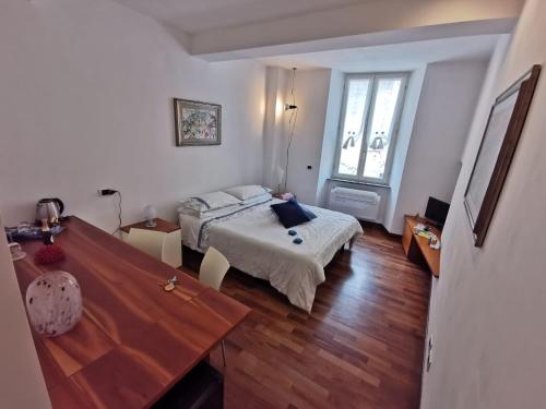 a bedroom with a bed and a desk and a table at Margot in Vernazza