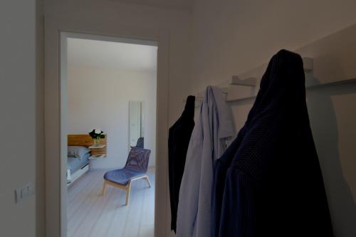 an open door to a room with a blue chair at Pane e Marmellata in Sant'Agnello