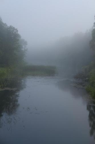 a misty river in the middle of a field at Amatų kalnelis in Anykščiai