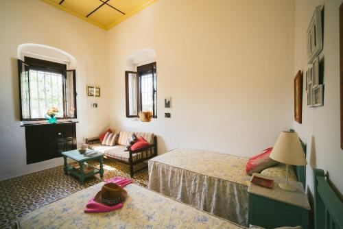 a bedroom with two beds and a living room at Villa La Jara Sanlúcar in Sanlúcar de Barrameda