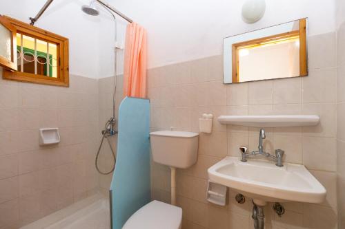 a bathroom with a toilet and a sink at Alexandros Studios by Estia in Benitses