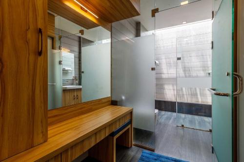 a bathroom with a mirror and a shower at Lakeside Summers by VEO - Part of StayVista in Trimbak