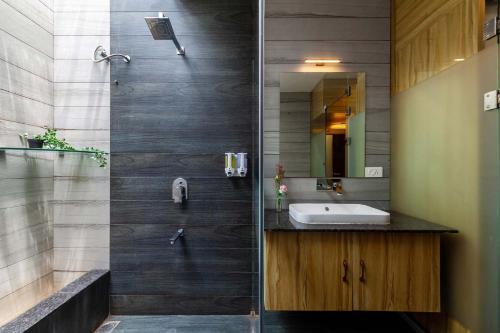 a bathroom with a sink and a shower at Lakeside Summers by VEO - Part of StayVista in Trimbak