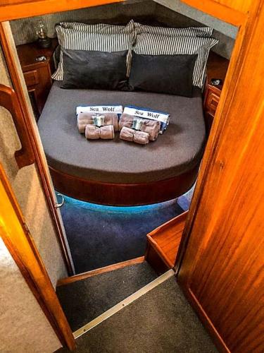 a small bed with two pillows on a boat at Motor Yacht Sea Wolf in Lymington