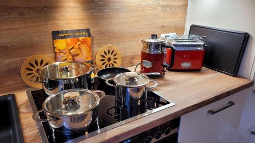 a counter with pots and pans on a stove at Ferienwohnung Festungsblick Königstein in Königstein an der Elbe