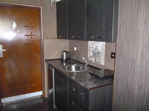 a kitchen with a sink and a counter top at batumi orbi sea tawers in Batumi