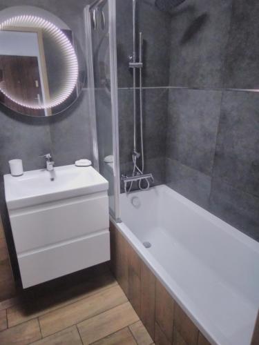 a bathroom with a tub and a sink and a shower at Miło i kolorowo.... in Giżycko