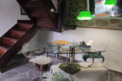 a dining room with a glass table and chairs at La casa de la Tina in Porquera de Santullán