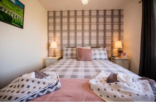 a bedroom with a large bed with two night stands at Annie's Corner - Fort William in Caol