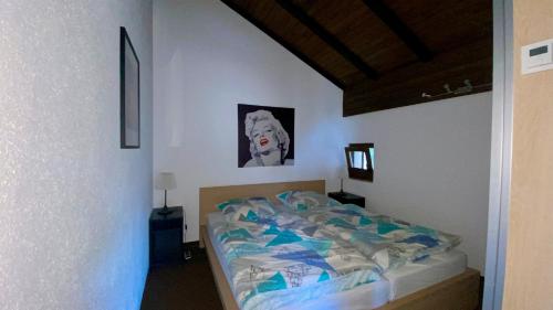 a bedroom with a bed and a picture of a dog at Ferienwohnung Adlerhorst Ruhpolding in Ruhpolding