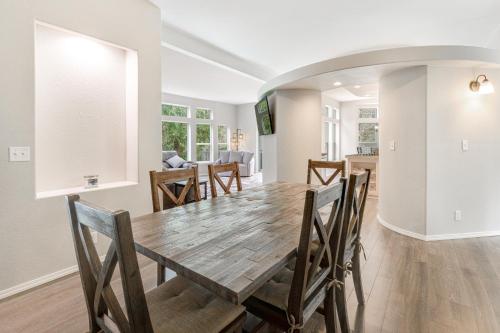 a dining room and living room with a wooden table and chairs at RiverSong in Tillamook