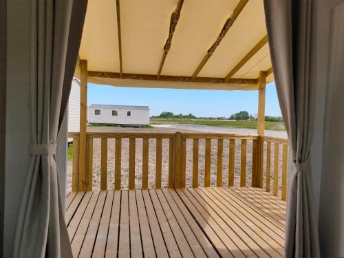 eine Terrasse mit Blick auf einen Anhänger in der Unterkunft DOMAINE DE LA GRANGE DES CHAMPS in Lorris