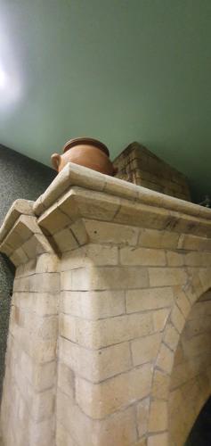 a vase sitting on top of a stone wall at Guest house YEREVAN in Yerevan